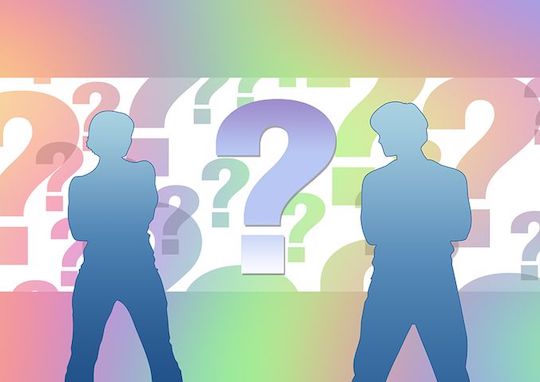 Two silhouettes of a man and woman with their arms crossed surrounded by giant question marks in multiple colors. 