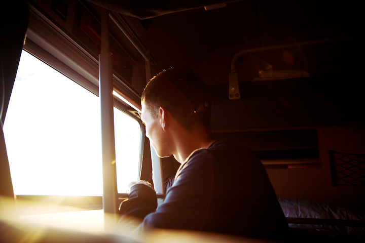 Person looking out the window of a train. 