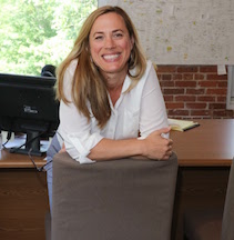 Woman smiling in an office. 