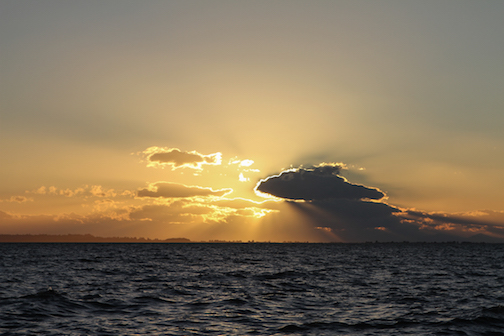 Beautiful sunset over a body of water with some clouds. 