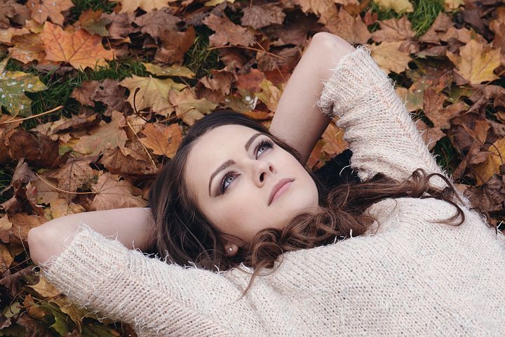 Woman lying on her back looking upward at the sky. 