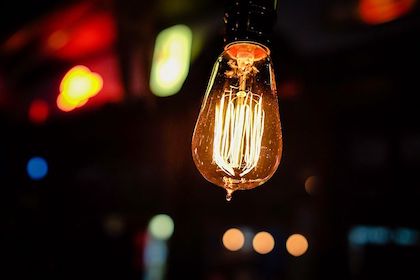 Close up shot of a lit light bulb, illustrating creativity. 